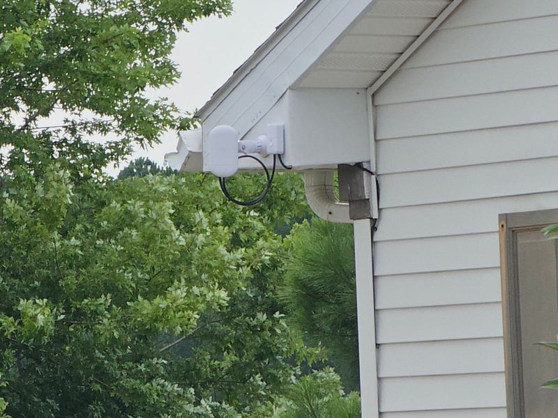 Outdoor wireless bridge radio mounted under a roof gable